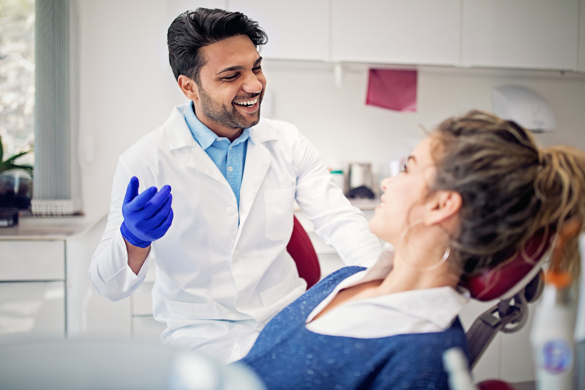 dentist smiling having a conversation with patient