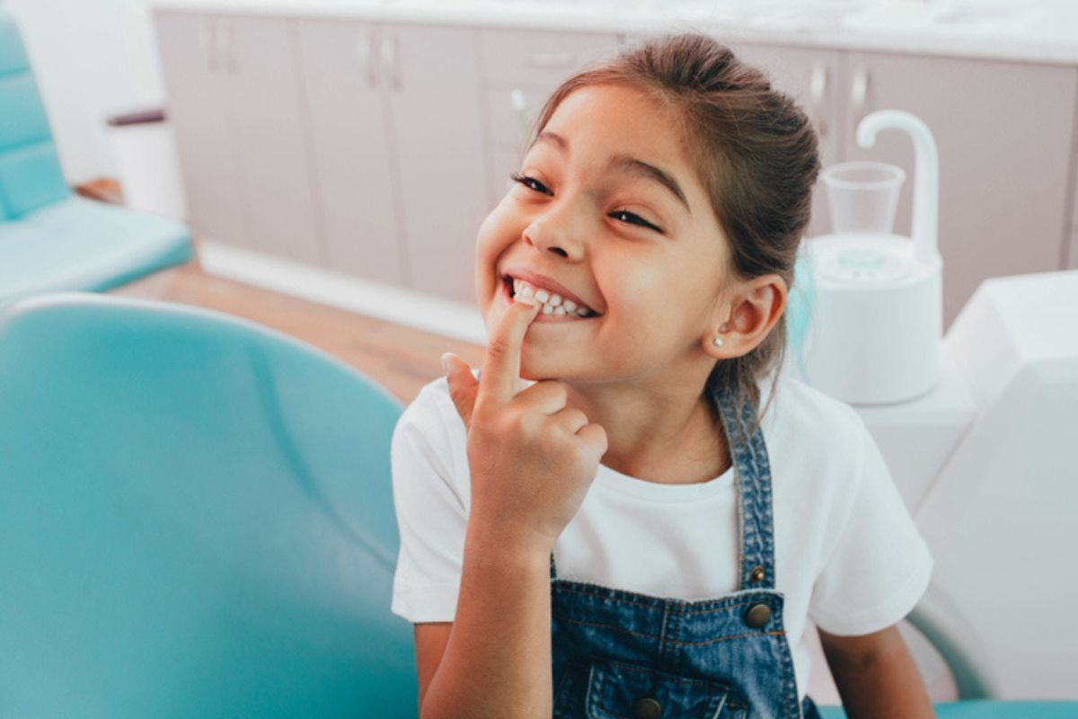 Child smiling at the dentist after her appointment.