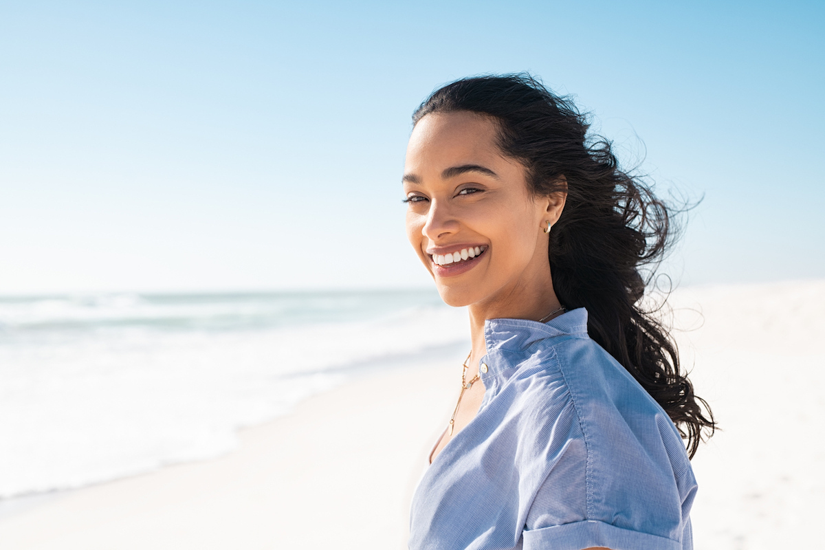 woman on the beach smiling